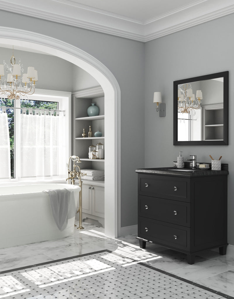 A luxurious bathroom featuring a freestanding tub, dark vanity, and marble floors with a patterned border.