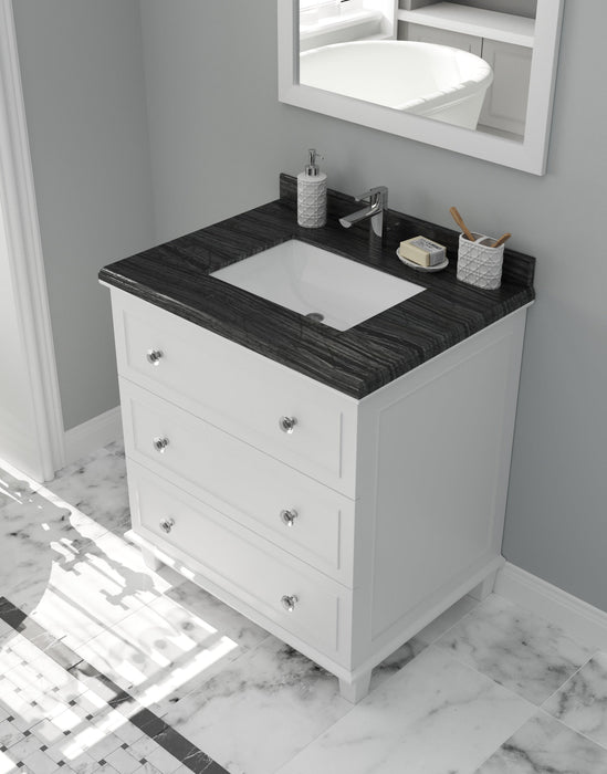 White vanity with black countertop, drawers, sink, and bathroom accessories.