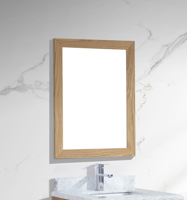Wooden-framed mirror on marble wall above sink and faucet. 
