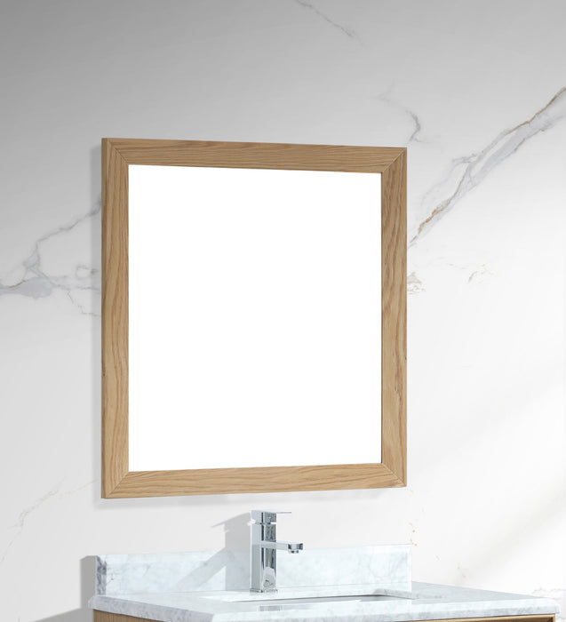 Bathroom mirror with light wood frame over vanity.