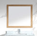 Square wooden-framed mirror over marble bathroom sink with chrome faucet.
