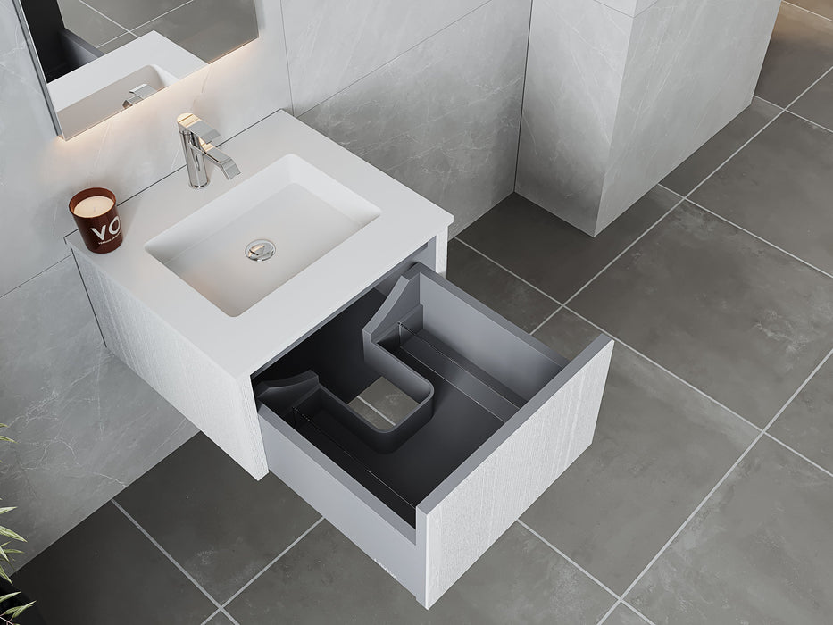 Open bathroom vanity drawer, white sink, grey tile flooring.