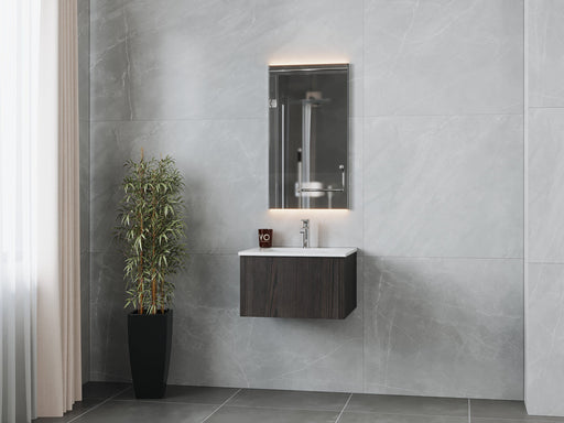 Modern bathroom with grey marble walls, vanity cabinet, sink, illuminated mirror, and decorative plant.
