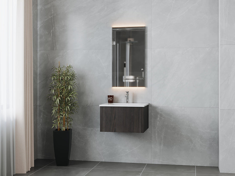 Modern bathroom with grey marble walls, vanity cabinet, sink, illuminated mirror, and decorative plant.
