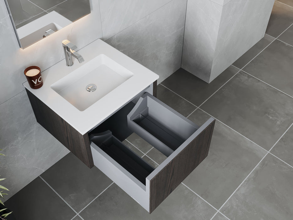 Modern bathroom vanity with a white countertop, sink, chrome faucet, open drawer, and gray tile flooring.