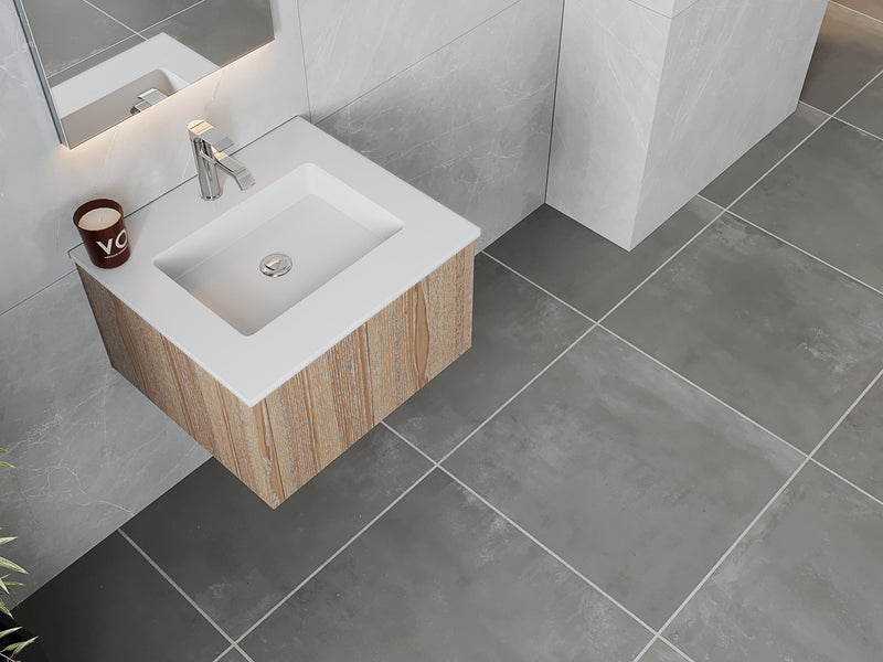 Bathroom vanity with white sink, wood cabinet, and gray tile floor.