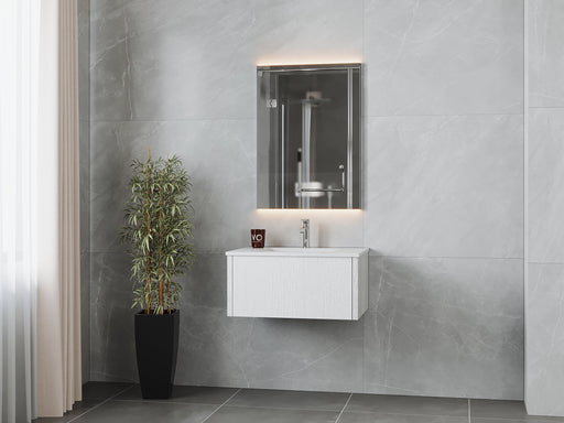 Modern bathroom with gray tiles, white vanity, illuminated mirror, and potted bamboo.