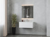Bathroom vanity with gray marble walls and lighted mirror.
