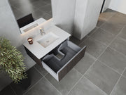 Bathroom vanity with white countertop, open drawer, and potted plant.