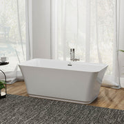 Modern white freestanding bathtub with chrome fixtures, positioned on a textured gray rug in a bright room with sheer curtains and wood flooring.
