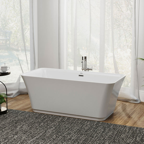 Modern white freestanding bathtub with chrome fixtures, positioned on a textured gray rug in a bright room with sheer curtains and wood flooring.