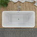 Modern white freestanding bathtub with chrome faucet, set against wooden wall with green plant and white towel.