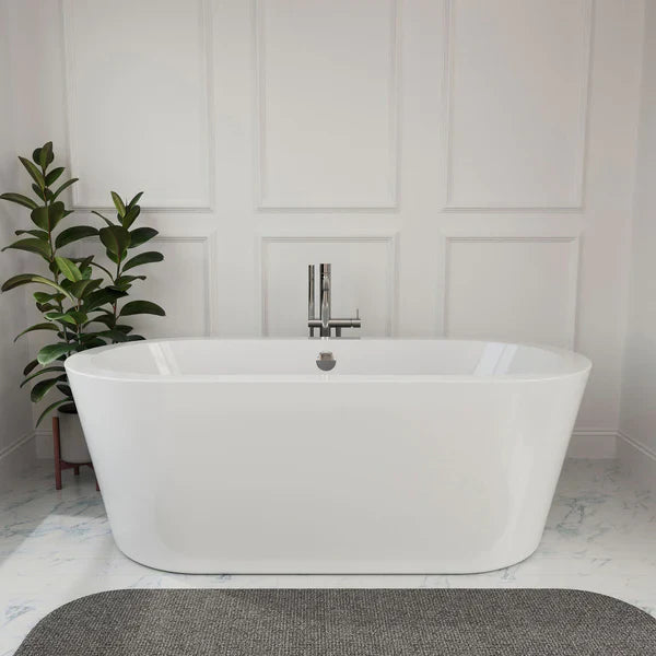 Modern white freestanding bathtub with chrome faucet, placed on marble floor beside a green potted plant against paneled wall.