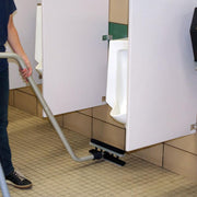 EDIC CR2 Touch Free Restroom Cleaning System 2700RC person cleaning floor with squeegee.