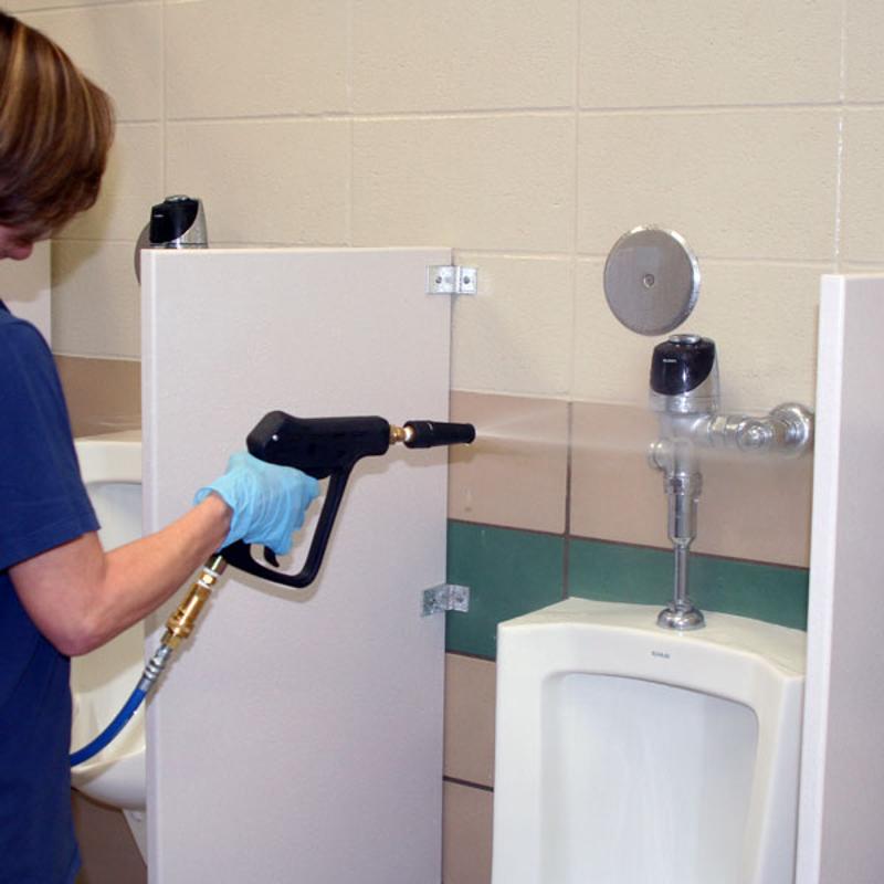 EDIC CR2 Touch Free Restroom Cleaning System 2700RC person cleaning urinal with gun.