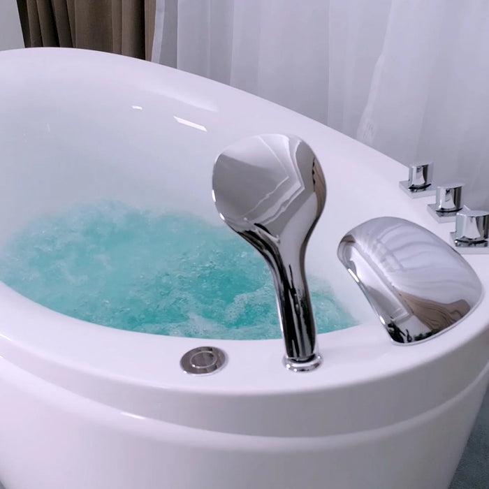 White bathtub filled with turquoise water and chrome faucet, with bubbles and jets creating a swirling effect.