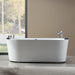 Modern white freestanding bathtub with chrome fixtures, positioned next to large window overlooking trees and garden with natural light streaming in.