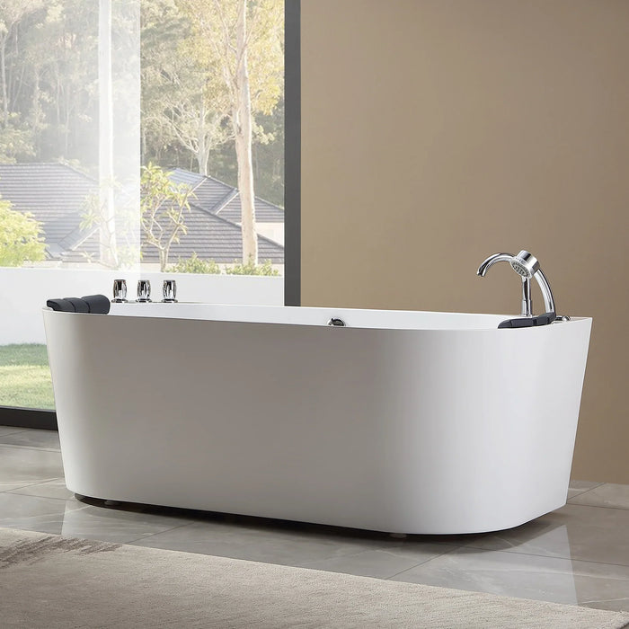 Modern white freestanding bathtub with chrome fixtures, positioned near large window overlooking trees and rooftops.