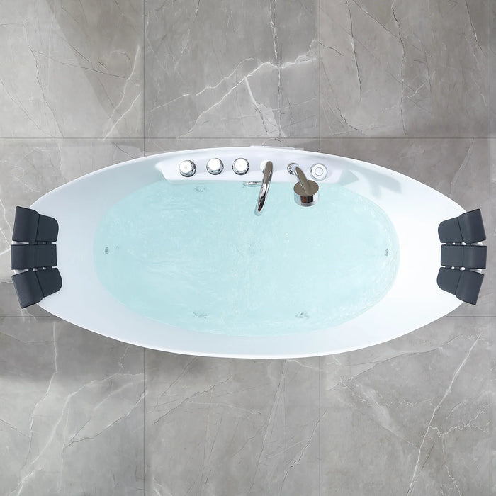 Modern white oval bathtub filled with light blue water, viewed from above, with chrome fixtures and black side supports, set on gray marble-like tiled floor.