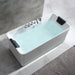 Modern white freestanding bathtub filled with light blue water, chrome faucet fixtures, and black headrests on marble-tiled bathroom floor