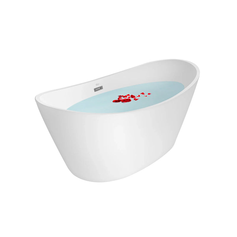Modern white freestanding bathtub filled with blue water and scattered red rose petals.
