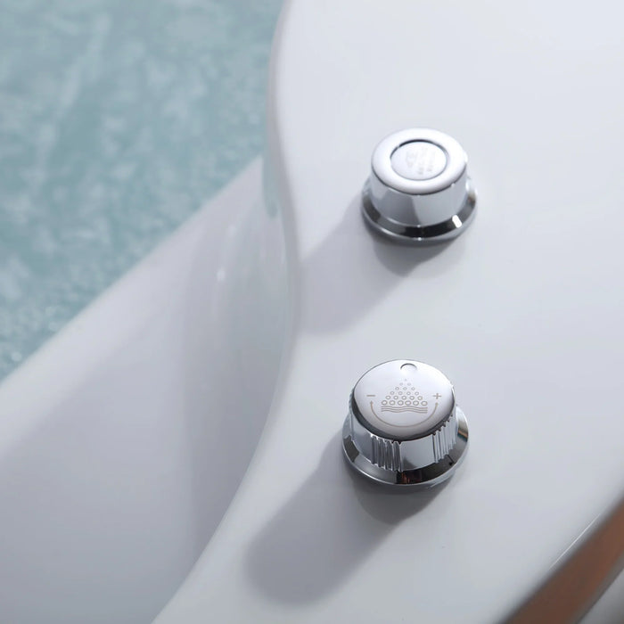 Two chrome water control knobs with textured surfaces on a white and pale green surface.