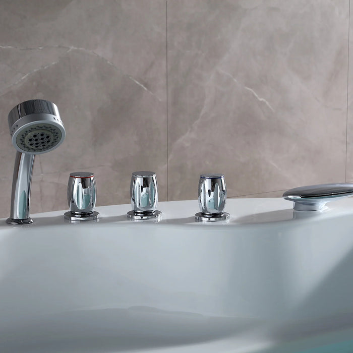 Chrome bathtub faucets and handheld showerhead on a marble-tiled wall with a white tub surface.
