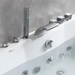 Modern white bathtub with sleek chrome faucet, handheld shower head, and multiple water jets against a gray textured wall.