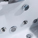 Close-up of white jacuzzi or hot tub with multiple chrome-rimmed jets and control knob