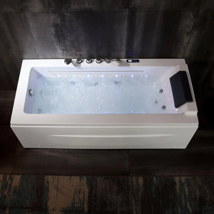 Modern white whirlpool bathtub with blue LED lights, digital control panel, and multiple jet nozzles against a dark concrete wall.