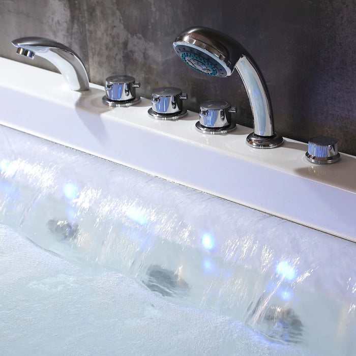 Sleek chrome bathtub faucets and handheld showerhead, with flowing water creating rippling white and blue reflections.