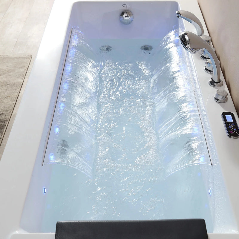 Modern hydrotherapy tub with cascading water jets, blue-tinted water, and digital control panel, creating a spa-like relaxation environment.
