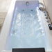 Modern hydrotherapy tub with cascading water jets, blue-tinted water, and digital control panel, creating a spa-like relaxation environment.