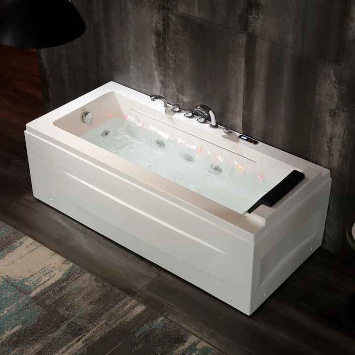 Modern white hydromassage bathtub with illuminated jets, positioned against a grungy concrete wall.