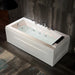 Modern white hydromassage bathtub with illuminated jets, positioned against a grungy concrete wall.
