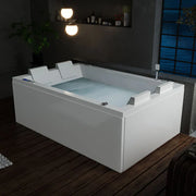 Modern white rectangular bathtub with water, illuminated by glowing spherical lights, placed on wooden floor near blue-tinted window at night.