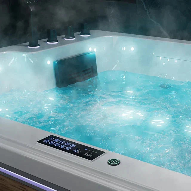 Steaming hot tub with turquoise water, bubbling jets, and digital control panel illuminated in soft blue light.