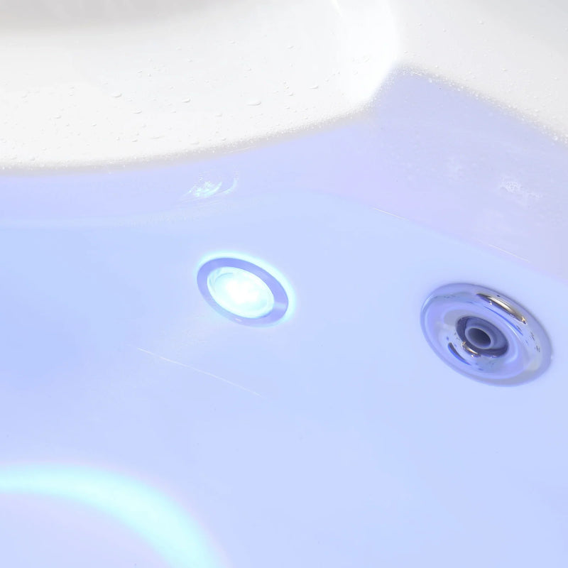 Two blue-tinted hot tub or spa jets against a light blue surface, with soft glowing light reflections.