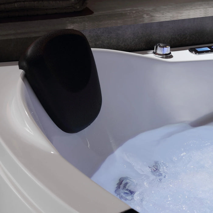 Black neck rest pillow attached to white jacuzzi tub with bubbling water and chrome fixtures