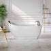 Modern white freestanding bathtub in elegant bathroom with herringbone floor, wooden side table, and potted palm plant.