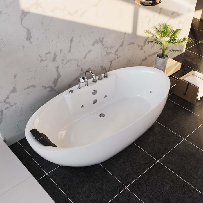 Modern white freestanding bathtub with chrome fixtures on black tiled floor, small green plant in concrete pot nearby, marble wall background
