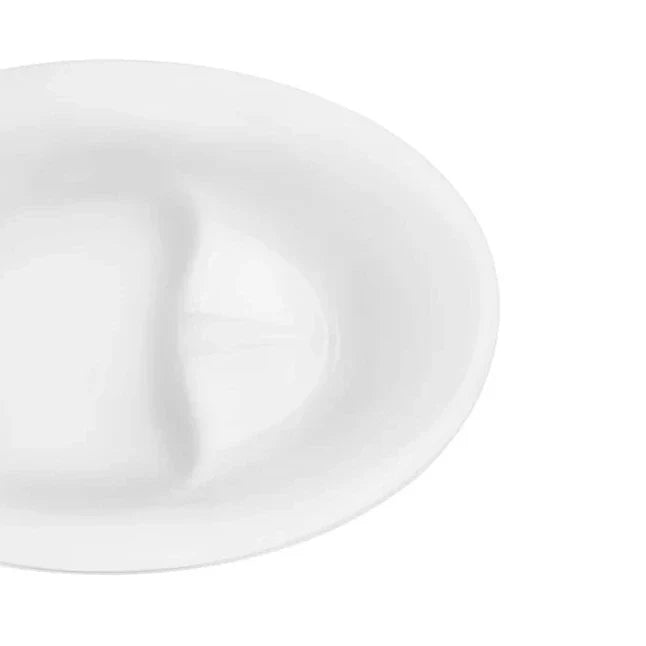 Clean white ceramic plate with smooth curved edges, photographed from an angle