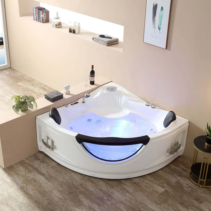 Luxurious corner whirlpool bathtub with blue lighting, black accents, and built-in headrests in a serene bathroom setting.