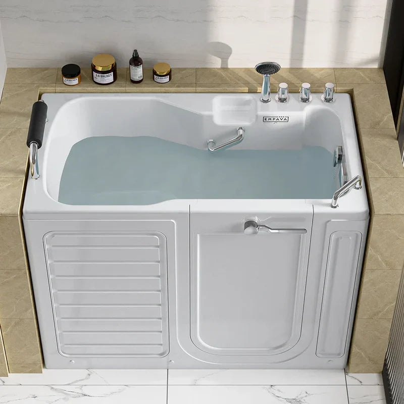 Walk-in bathtub filled with light blue water, with side door open and bath products on tiled shelf above.