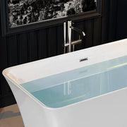 Modern white bathtub with chrome freestanding faucet, partially filled with teal water, set against dark paneled wall with cityscape window.