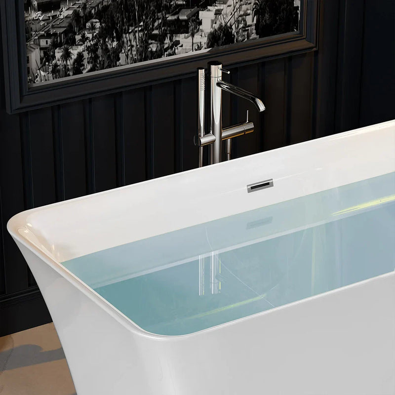 Modern white bathtub with chrome freestanding faucet, partially filled with teal water, set against dark paneled wall with cityscape window.
