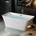Modern white freestanding bathtub filled with light blue water, placed on gray tile floor with side table and diffuser.