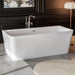 Modern white freestanding bathtub with sleek chrome faucet, set against dark paneled walls with decorative floor lamp and area rug.