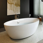 Modern white freestanding bathtub with gold-tinted drip art on dark wall, elegant mosaic floor tiles visible.