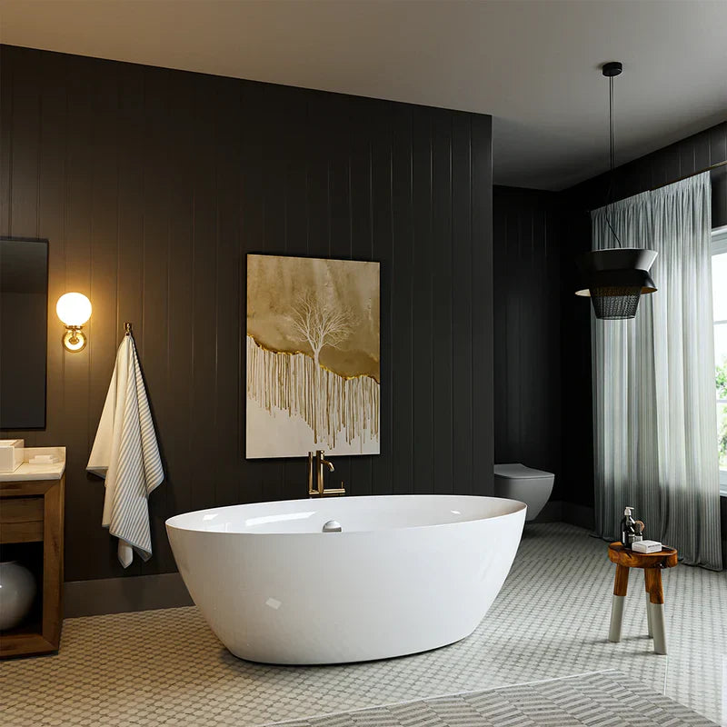 Modern bathroom with white freestanding tub, dark walls, gold-toned wall art, and soft lighting from a wall sconce and pendant lamp.